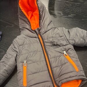 DKNY grey kids puffer jacket with orange accents